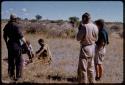 Dabe and William Donnellan skinning a springbok, Theunis Berger, Elizabeth Marshall Thomas, and Kernel Ledimo watching