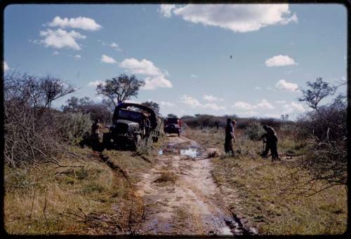 Expedition GMC truck on the side of a road, expedition members standing by