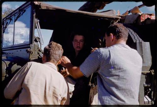 Elizabeth Marshall Thomas in cab of expedition GMC truck, William Donnellan and Theunis Berger