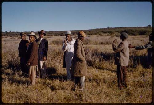 Group of men standing in grass