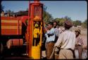 People at the Bakwena Store gas pump, expedition Dodge truck in the background