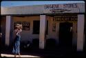 Woman walking by Bakwena Store