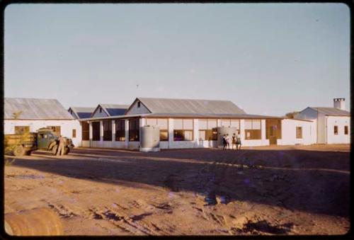 Buildings, truck and people outside