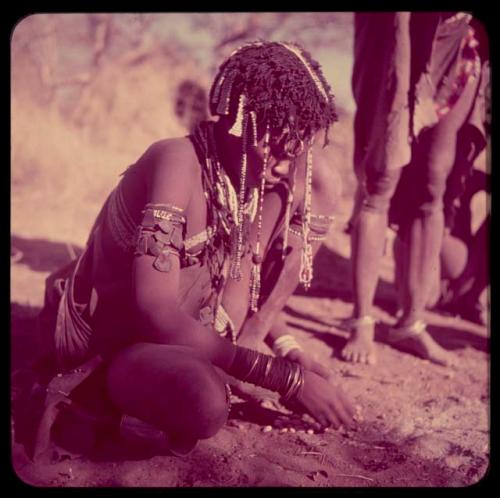 Food Gathering, "Manghettis": Girl from Band 10 cracking nuts, probably tsi