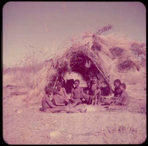 Groups, "Nuclear Family": Gau's family sitting in front of a skerm (left to right): ≠Toma, !Naishi, Be their mother, Gau, /Qui held by Khuan//a (Gau's second wife), /Gunda (husband of N!ai and son of Khuan//a by a former marriage with Bo), ≠Gao (son of Gau and Be)