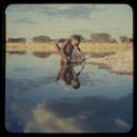 Boy sitting on a rock by pan