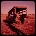 Man walking by Father Jean Marie's truck on "Boer War Memorial Day"