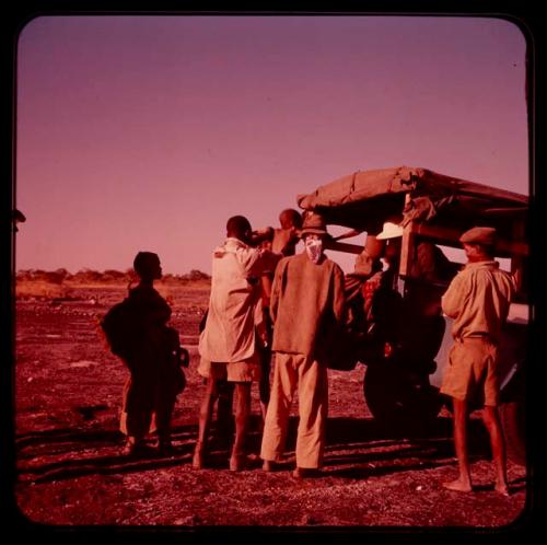 /Ti!kay's family getting in Father Jean Marie's truck on "Boer War Memorial Day"