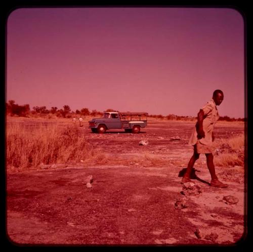 Man standing, with a truck in the background