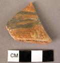 Red glazed pottery base fragment -