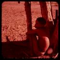 Boy sitting in the shade of a tree