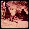 Man lying on the ground, with other people watching him