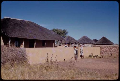 Houses, people standing in a courtyard