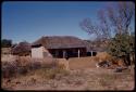 Two houses with a clay fence