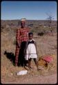 Woman and girl standing beside the road