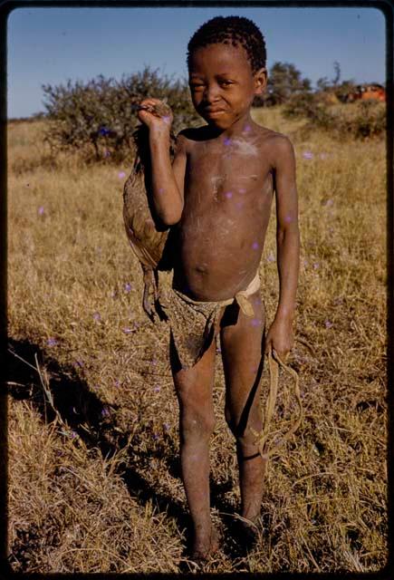 Boy carrying a bird