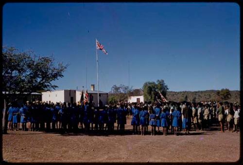 Girl and boy scouts standing in lines for a parade, ceremony on Queen Elizabeth's birthday