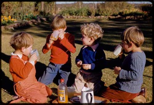 Grant family children sitting in a yard and drinking tea