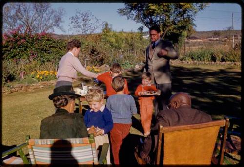 Grant family, Lorna Marshall, Chief Kgari Sechele sitting in a yard and drinking tea