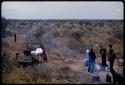 Expedition members standing around a fire