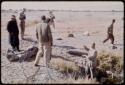 Expedition members standing by a waterhole