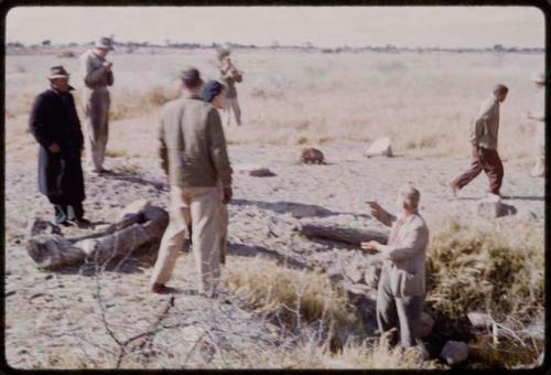 Expedition members standing by a waterhole