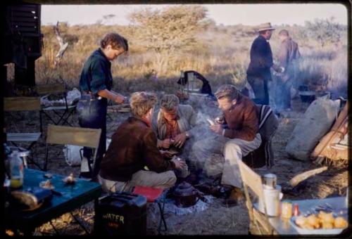 Expedition members cleaning lion teeth at camp