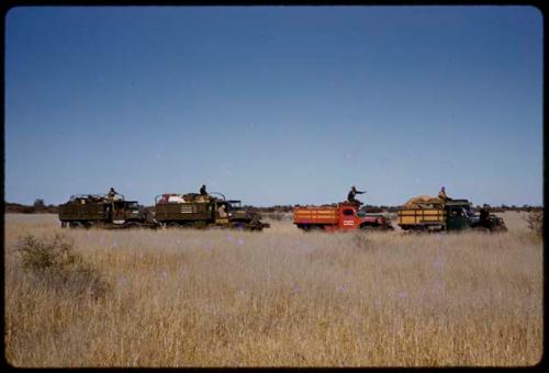 Expedition trucks driving in a line