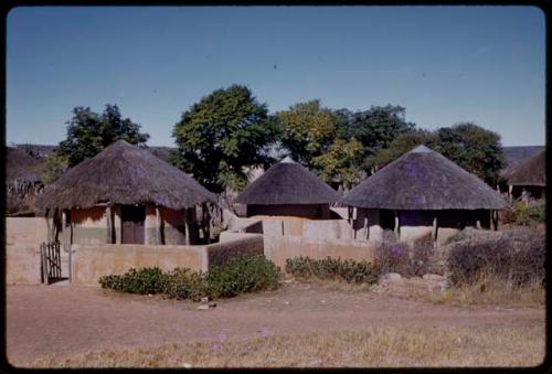 Three houses by a road