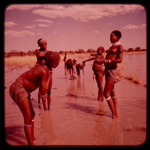 Group of young people standing in the water