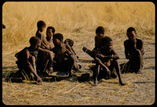 Group of people sitting, receiving tobacco