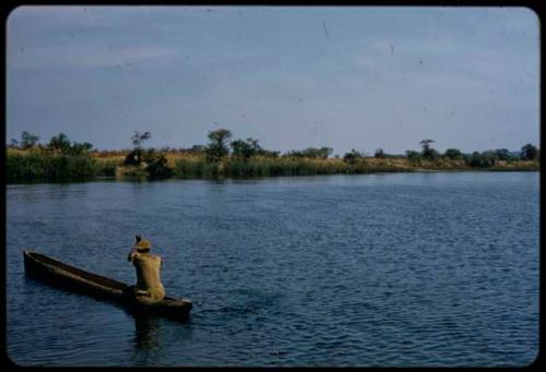 Man sitting in a mokoro (makoro) in the Okavango River