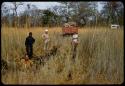 Heinrich Neumann, Philip Hameva, Nicolaas Jacobus van Warmelo and Kurt Ahrens next to ruts left by expedition truck crossing the Oshimporo omuramba