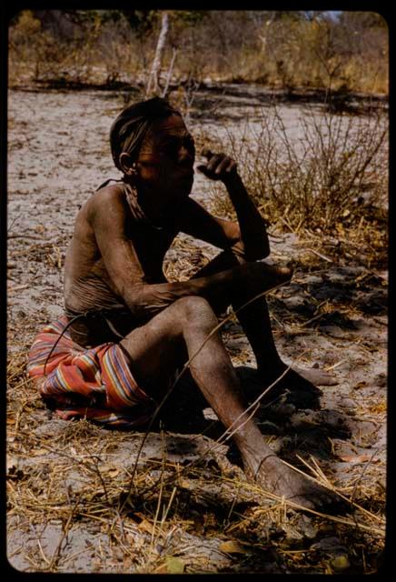 Woman wearing a cloth skirt, sitting