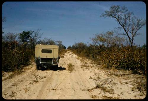 Expedition truck driving on a road through sand near Omboloka