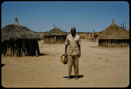 Elia, a Kuanyama chief, standing in his kraal