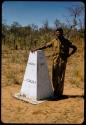 Heinrich Neumann standing next to a beacon on the border between Angola and South West Africa