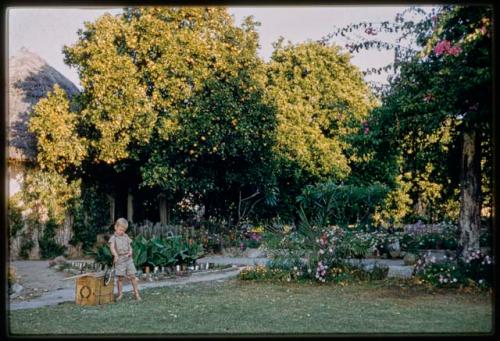 Mr. Kruger's son standing in the garden at the Native Commissioner's home