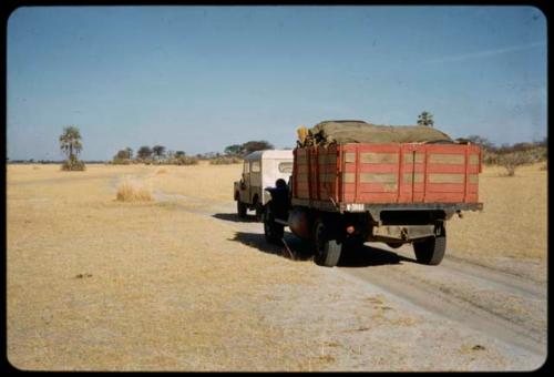 Expedition trucks driving through the flats below Rundu