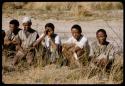 Men sitting, waiting to be paid by Mr. Kruger for work on a fire break