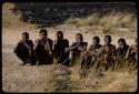 Men sitting, waiting to be paid by Mr. Kruger for work on a fire break