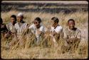 Men sitting, waiting to be paid by Mr. Kruger for work on a fire break