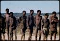 Men standing in line, waiting to be paid by Mr. Kruger for work on a fire break