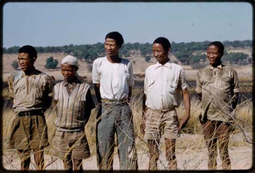 Five men standing in line, waiting to be paid by Mr. Kruger for work on a fire break