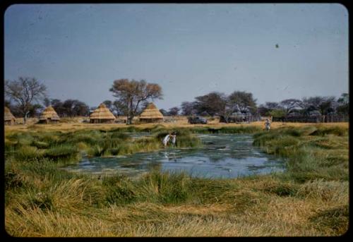 Waterhole, with rondavels (round houses) in the background