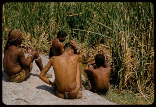 Four people sitting next to the Gautscha waterhole