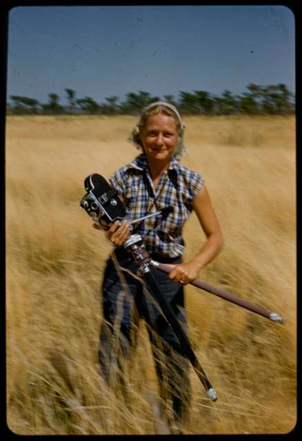 Heidi von Koenen standing and holding a camera and tripod