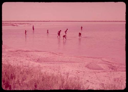 People bathing in a water-filled pan, distant view