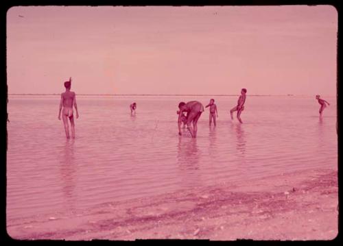 People bathing in a water-filled pan