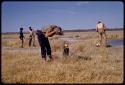 Expedition members and trucks by a waterhole, Elizabeth Marshall Thomas and others washing